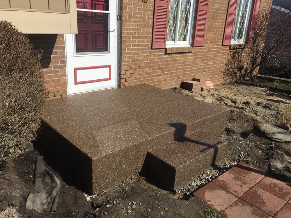 Completed concrete stoop and steps at a home entrance