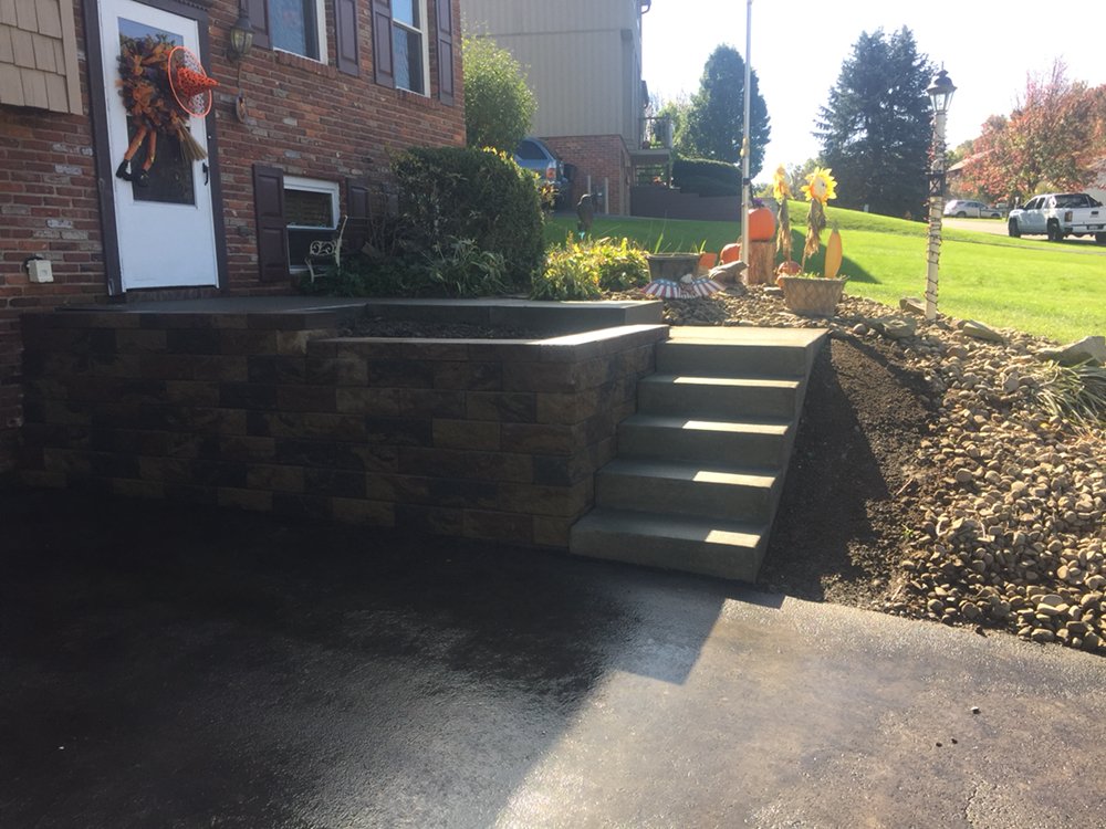 Completed Versa-Lok retaining wall and concrete steps at a residential home